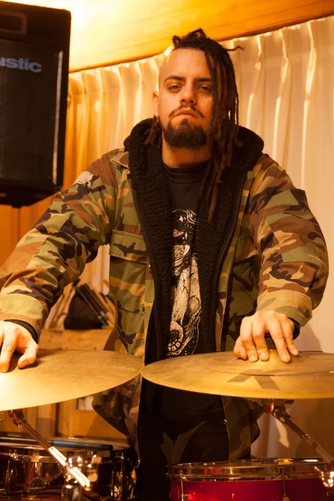 Drummer with Dark K Cymbals and militar camouflage jacket